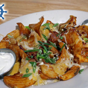 Loaded Beer Cheese Fries - Fries topped with beer cheese, three cheese blend, bacon and green onions.